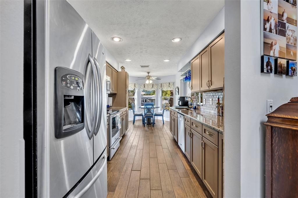 Dining room, Interior, Kitchen, Recessed Lighting, Stainless Steel Appliances, Wood Texture Flooring