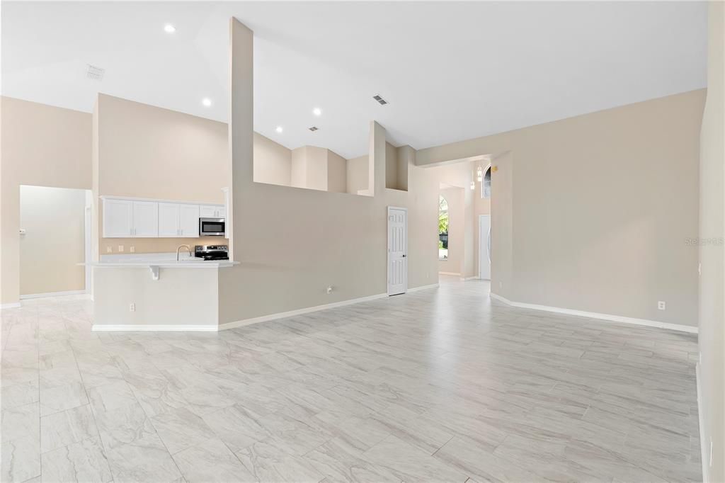 Empty room, Interior, Kitchen, Recessed Lighting, Stainless Steel Appliances, Wood Texture Flooring