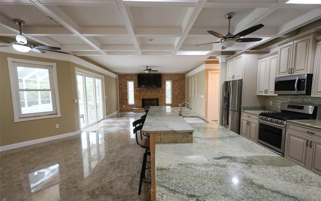 Fireplace, Interior, Kitchen, Recessed Lighting, Stainless Steel Appliances, Stone Walls