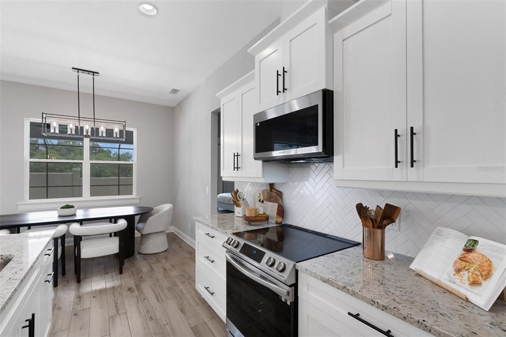 Dining room, Interior, Kitchen, Pendant Lights, Recessed Lighting, Stainless Steel Appliances, Wood Texture Flooring