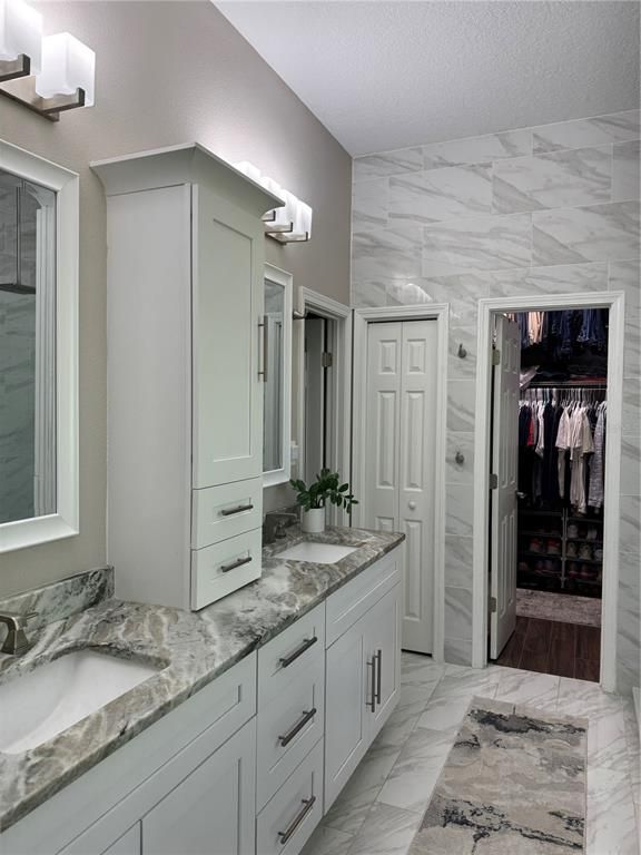 Bathroom, Dual Sink Vanities, Interior, Marble, Marble Walls, Walk-in Closets, Wood Texture Flooring
