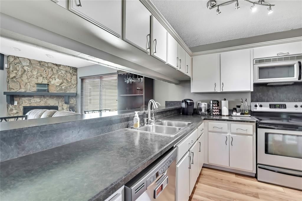 Fireplace, Interior, Kitchen, Stainless Steel Appliances, Stone Walls, Wood Texture Flooring