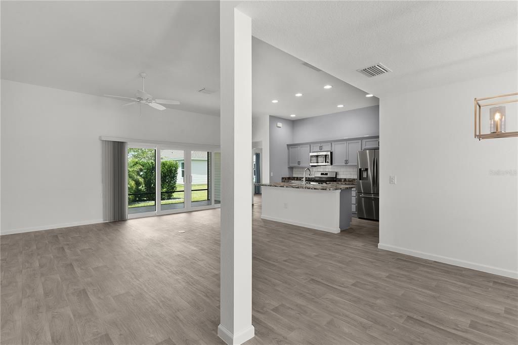 Empty room, Interior, Kitchen, Recessed Lighting, Stainless Steel Appliances, Wood Texture Flooring