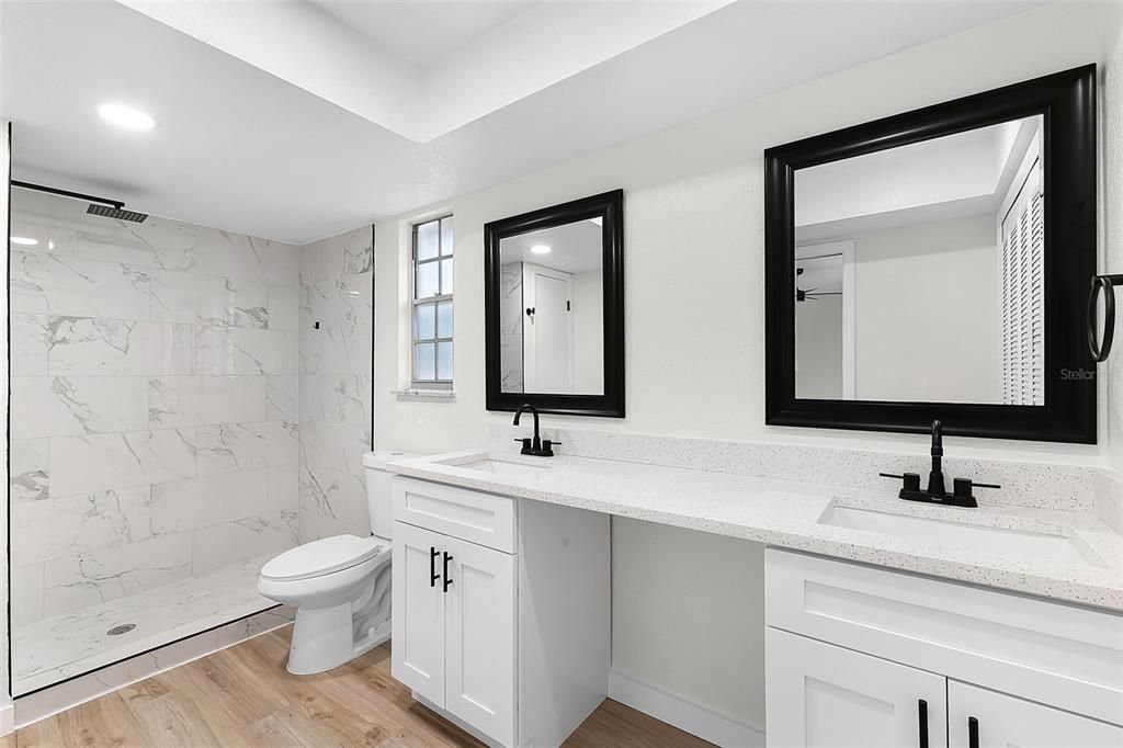 Bathroom, Dual Sink Vanities, Interior, Marble Walls, Recessed Lighting, Wood Texture Flooring