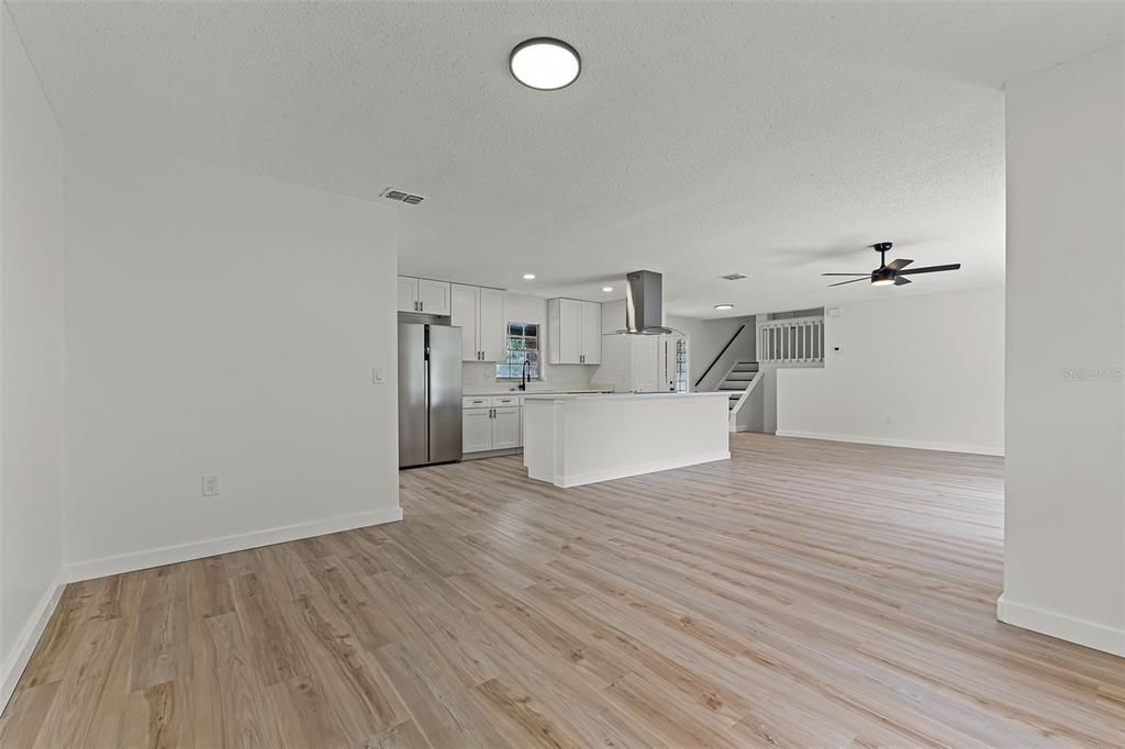 Empty room, Interior, Kitchen, Recessed Lighting, Stainless Steel Appliances, Wood Texture Flooring