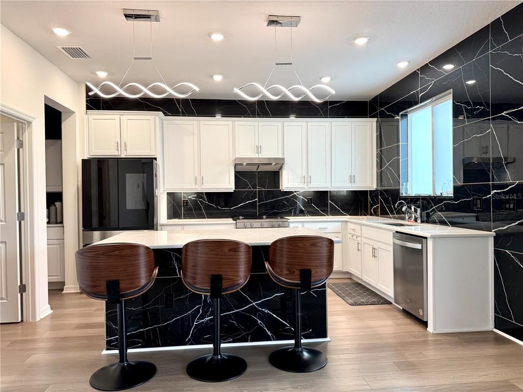 Interior, Kitchen, Marble Walls, Pendant Lights, Recessed Lighting, Stainless Steel Appliances, Wood Texture Flooring