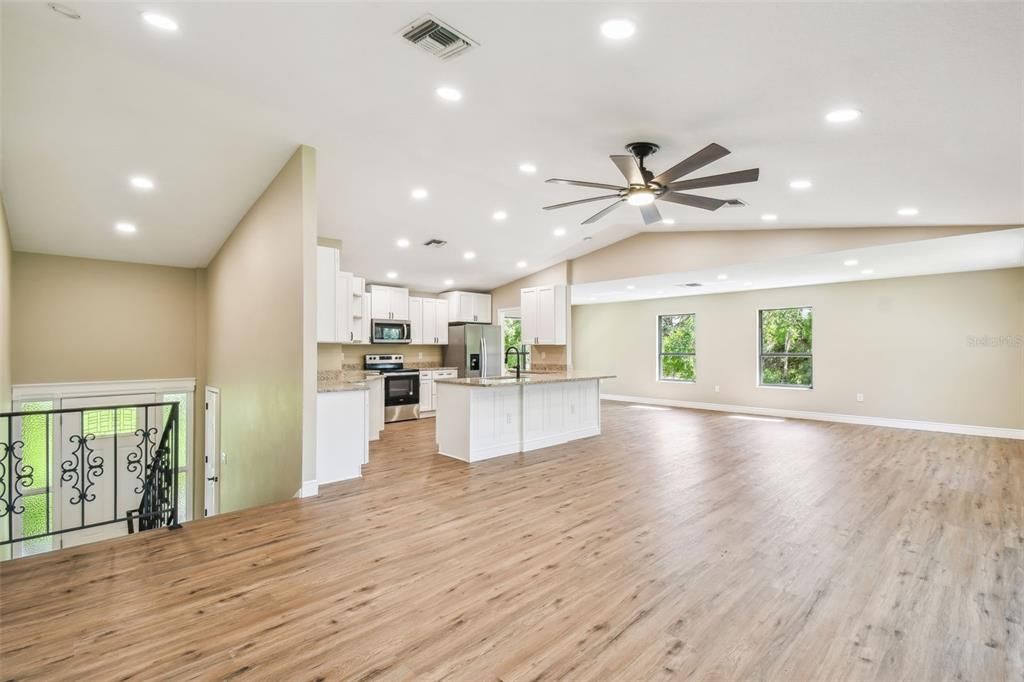 Empty room, Interior, Kitchen, Recessed Lighting, Stainless Steel Appliances, Wood Texture Flooring