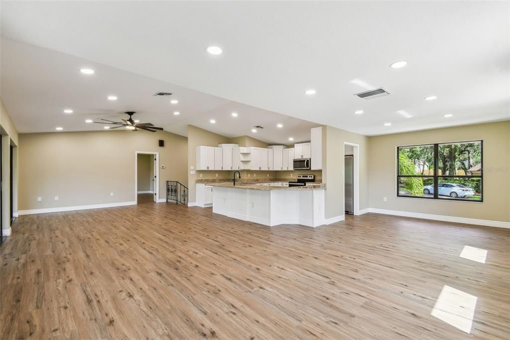 Empty room, Interior, Kitchen, Recessed Lighting, Stainless Steel Appliances, Wood Texture Flooring