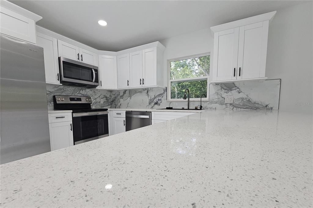 Interior, Kitchen, Marble Walls, Recessed Lighting, Stainless Steel Appliances