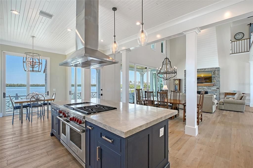 Dining room, Fireplace, Interior, Kitchen, Living room, Pendant Lights, Recessed Lighting, Stainless Steel Appliances, Water, Wood Texture Flooring