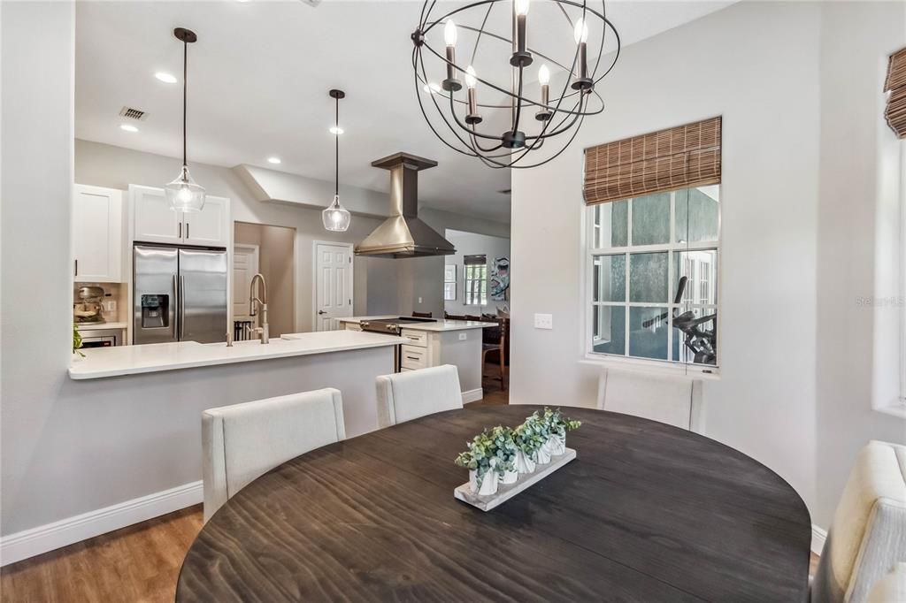 Chandelier, Dining room, Interior, Kitchen, Pendant Lights, Recessed Lighting, Stainless Steel Appliances, Wood Texture Flooring