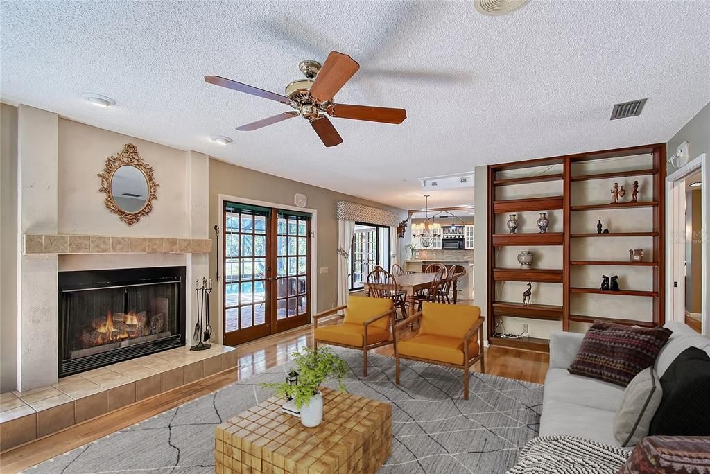 Chandelier, Dining room, Fireplace, Interior, Living room, Pendant Lights, Recessed Lighting, Wood Texture Flooring