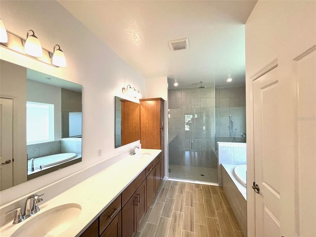 Bathroom, Dual Sink Vanities, Glass Shower, Interior, Recessed Lighting, Wood Texture Flooring