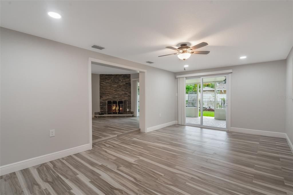 Empty room, Fireplace, Interior, Recessed Lighting, Stone Walls, Wood Texture Flooring