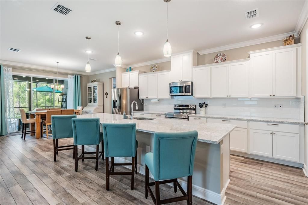 Dining room, Interior, Kitchen, Pendant Lights, Recessed Lighting, Stainless Steel Appliances, Wood Texture Flooring