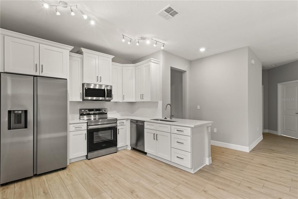 Interior, Kitchen, Recessed Lighting, Stainless Steel Appliances, Wood Texture Flooring