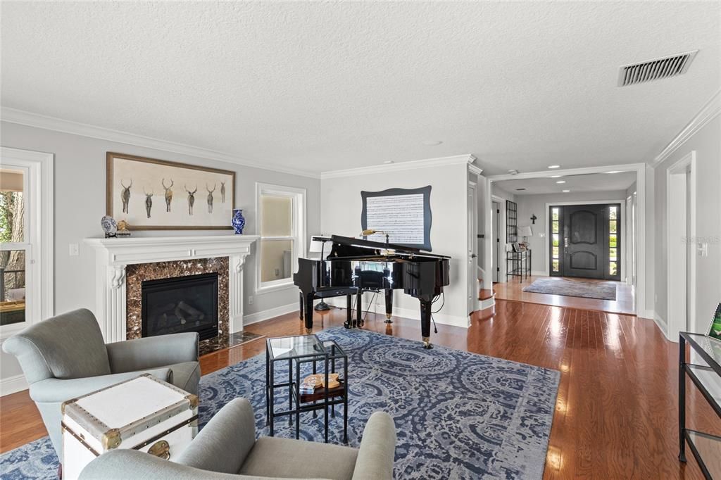 Fireplace, Interior, Living room, Piano, Recessed Lighting, Wood Texture Flooring