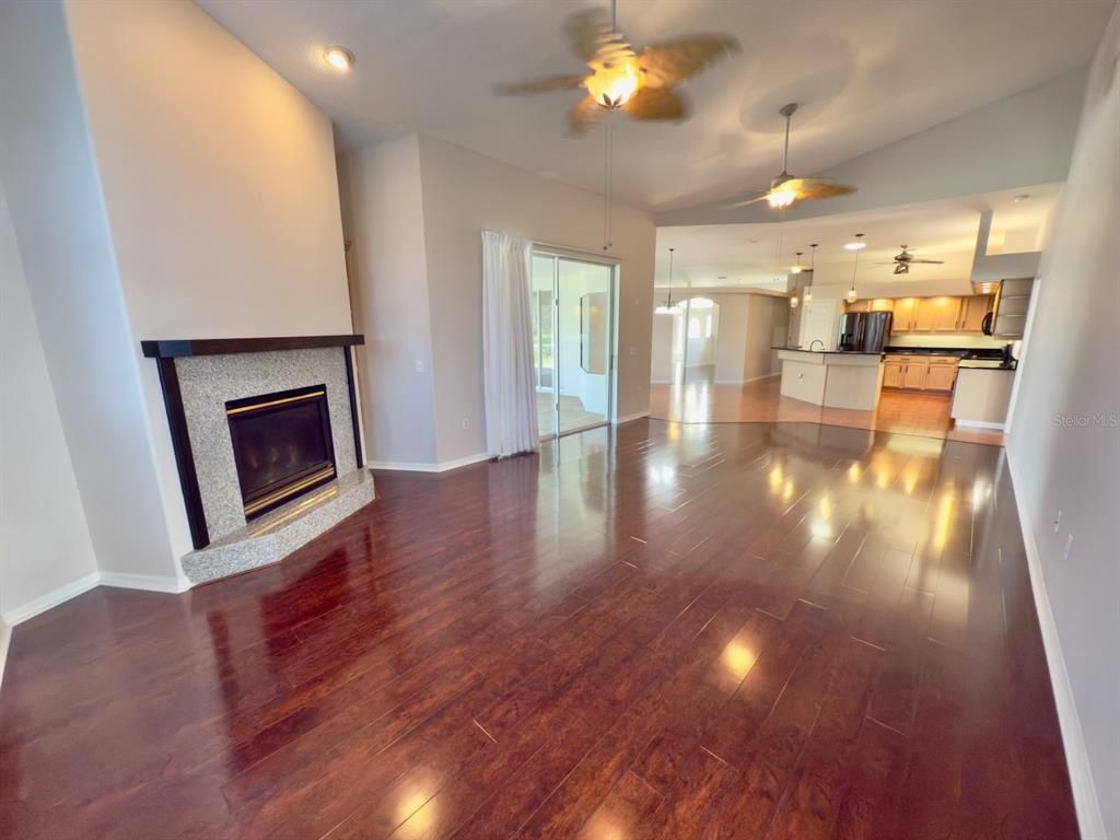 Empty room, Fireplace, Interior, Kitchen, Pendant Lights, Recessed Lighting, Wood Texture Flooring