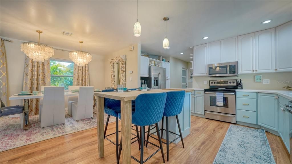 Chandelier, Dining room, Interior, Kitchen, Pendant Lights, Recessed Lighting, Stainless Steel Appliances, Wood Texture Flooring