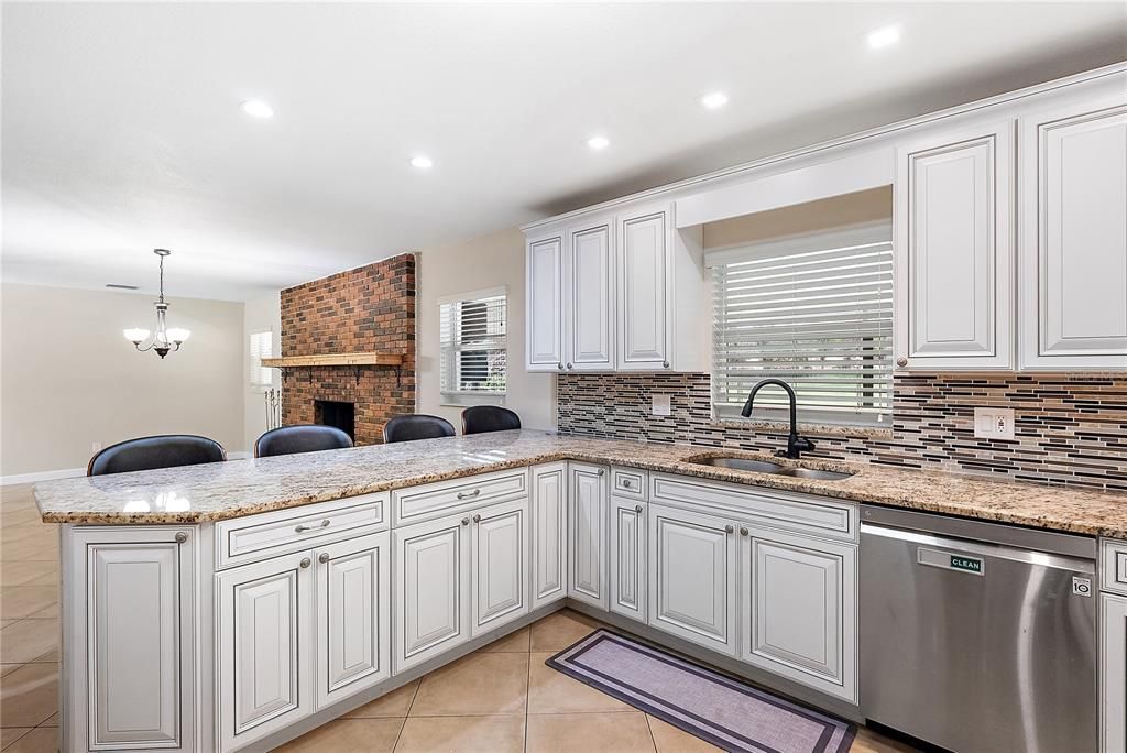 Fireplace, Interior, Kitchen, Pendant Lights, Recessed Lighting, Stainless Steel Appliances, Stone Walls