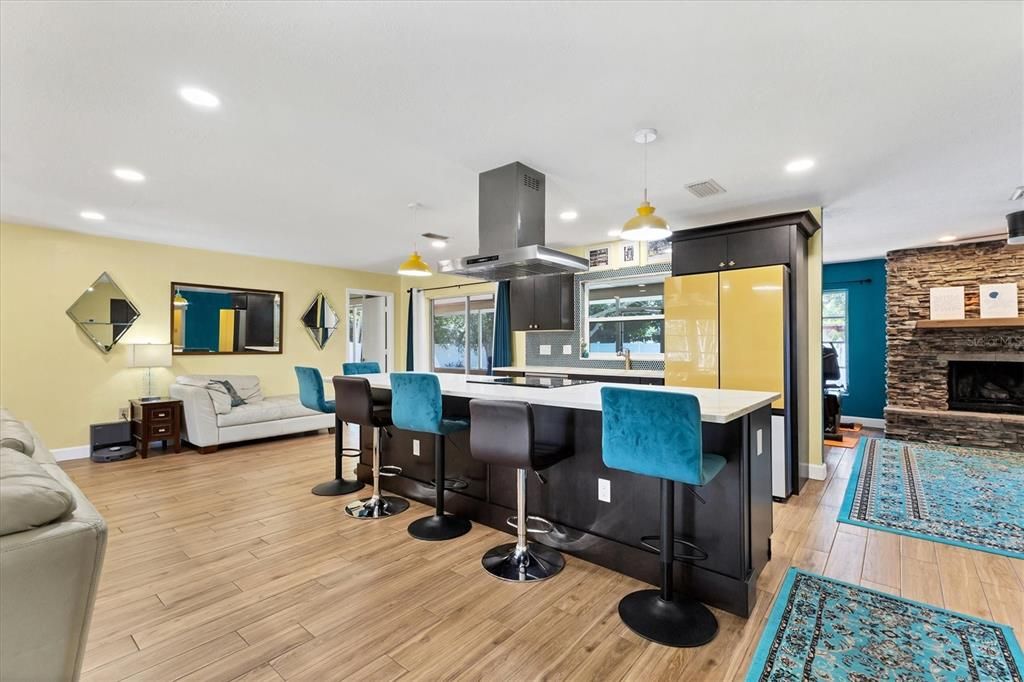 Fireplace, Interior, Kitchen, Pendant Lights, Recessed Lighting, Stainless Steel Appliances, Stone Walls, Wood Texture Flooring