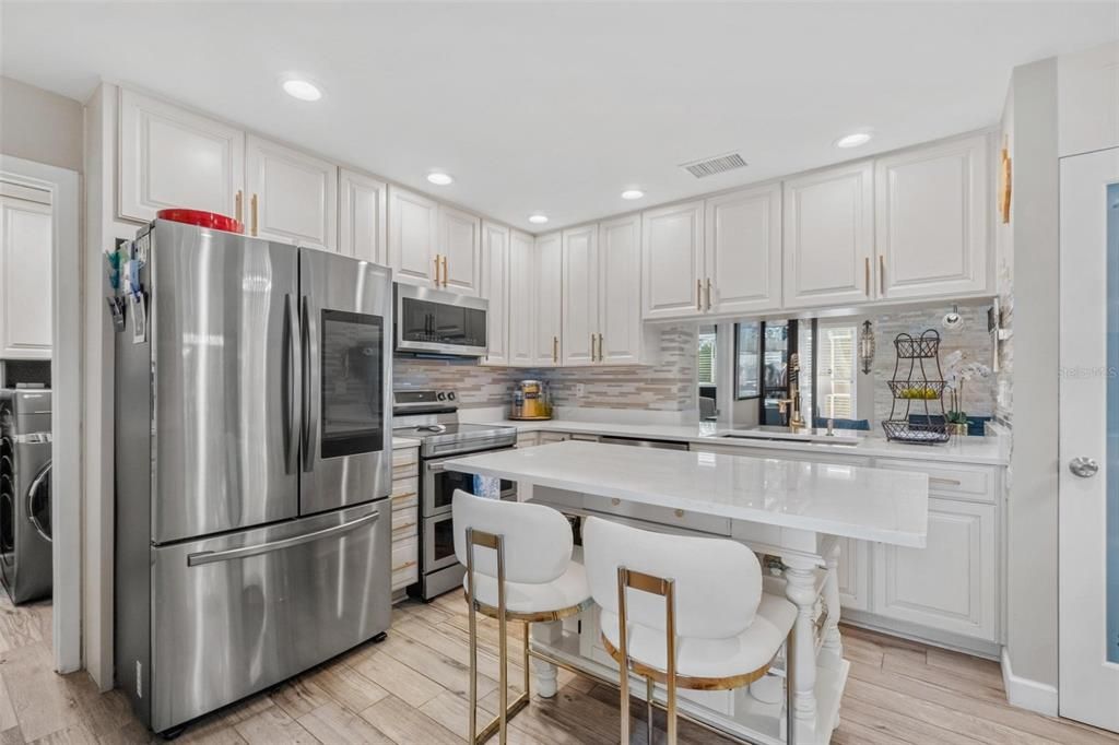 Interior, Kitchen, Recessed Lighting, Stainless Steel Appliances, Washer, Wood Texture Flooring