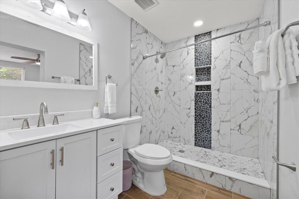 Bathroom, Glass Shower, Interior, Marble Walls, Recessed Lighting, Wood Texture Flooring