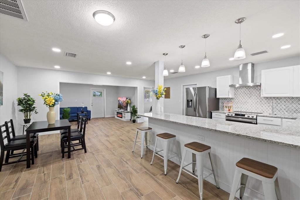 Dining room, Interior, Kitchen, Pendant Lights, Recessed Lighting, Stainless Steel Appliances, Wood Texture Flooring