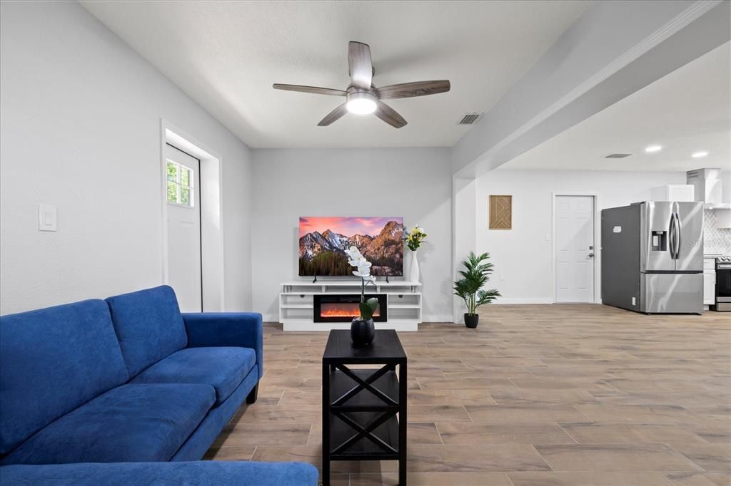 Fireplace, Interior, Kitchen, Living room, Recessed Lighting, Stainless Steel Appliances, Wood Texture Flooring