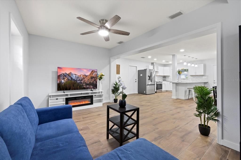 Fireplace, Interior, Kitchen, Living room, Pendant Lights, Recessed Lighting, Stainless Steel Appliances, Wood Texture Flooring