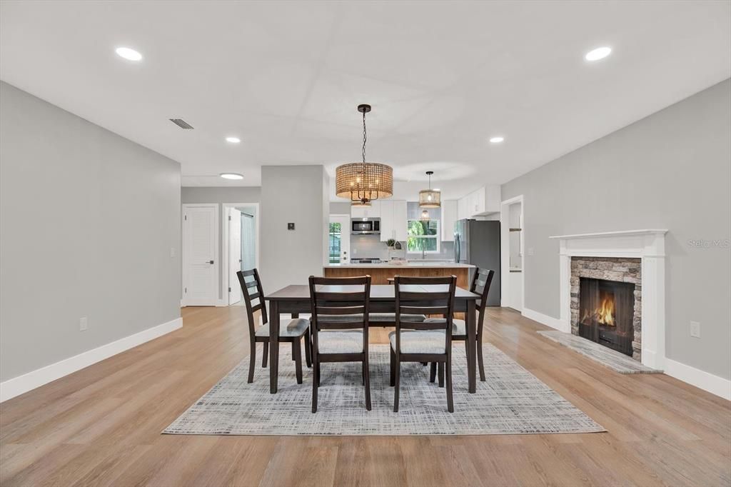 Dining room, Fireplace, Interior, Kitchen, Pendant Lights, Recessed Lighting, Stainless Steel Appliances, Wood Texture Flooring