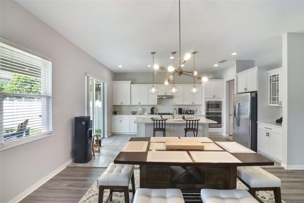 Dining room, Interior, Kitchen, Pendant Lights, Recessed Lighting, Stainless Steel Appliances, Wood Texture Flooring