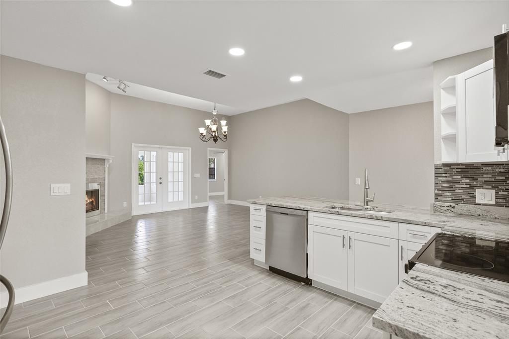 Chandelier, Fireplace, Interior, Kitchen, Recessed Lighting, Wood Texture Flooring
