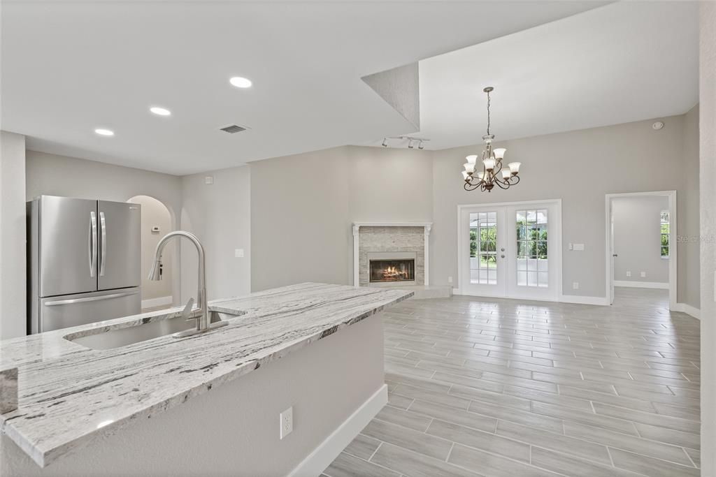 Chandelier, Fireplace, Interior, Kitchen, Recessed Lighting, Wood Texture Flooring