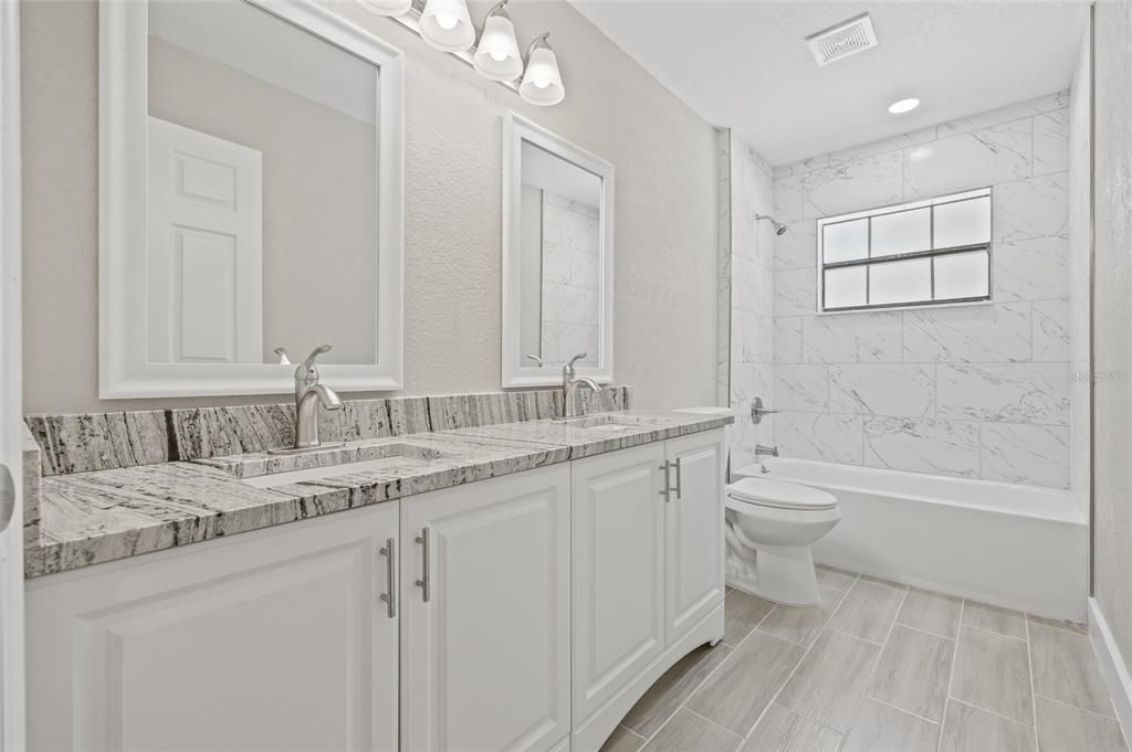 Bathroom, Dual Sink Vanities, Interior, Marble Walls, Recessed Lighting, Wood Texture Flooring