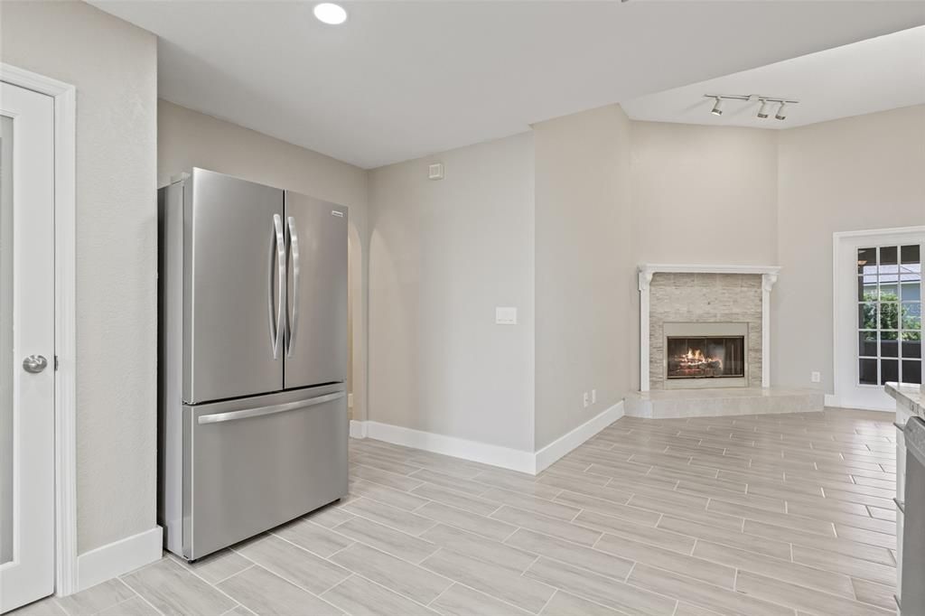 Fireplace, Interior, Kitchen, Recessed Lighting, Stainless Steel Appliances, Wood Texture Flooring