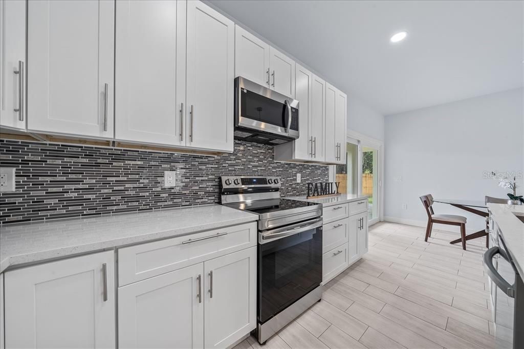 Dining room, Interior, Kitchen, Recessed Lighting, Stainless Steel Appliances, Wood Texture Flooring