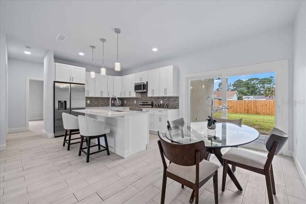 Dining room, Interior, Kitchen, Pendant Lights, Recessed Lighting, Stainless Steel Appliances, Wood Texture Flooring