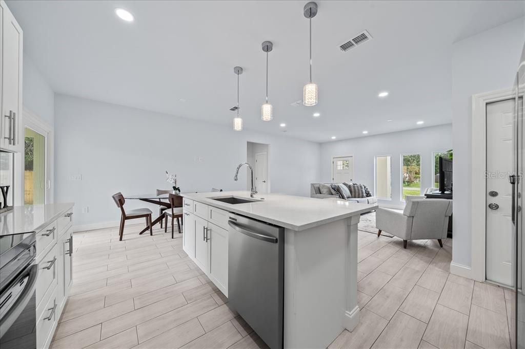 Dining room, Interior, Kitchen, Living room, Pendant Lights, Recessed Lighting, Stainless Steel Appliances, Wood Texture Flooring