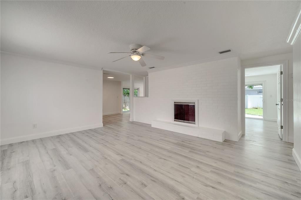 Empty room, Fireplace, Interior, Recessed Lighting, Stone Walls, Wood Texture Flooring