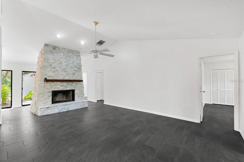 Empty room, Fireplace, Interior, Recessed Lighting, Stone Walls, Wood Texture Flooring