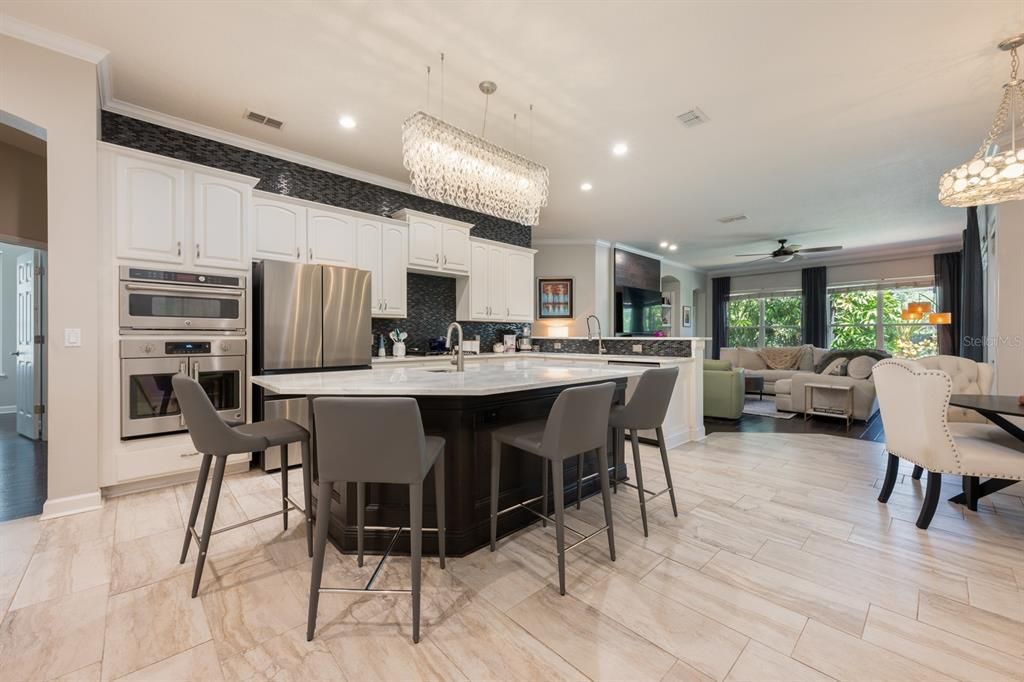Chandelier, Dining room, Interior, Kitchen, Living room, Pendant Lights, Recessed Lighting, Stainless Steel Appliances, Wood Texture Flooring