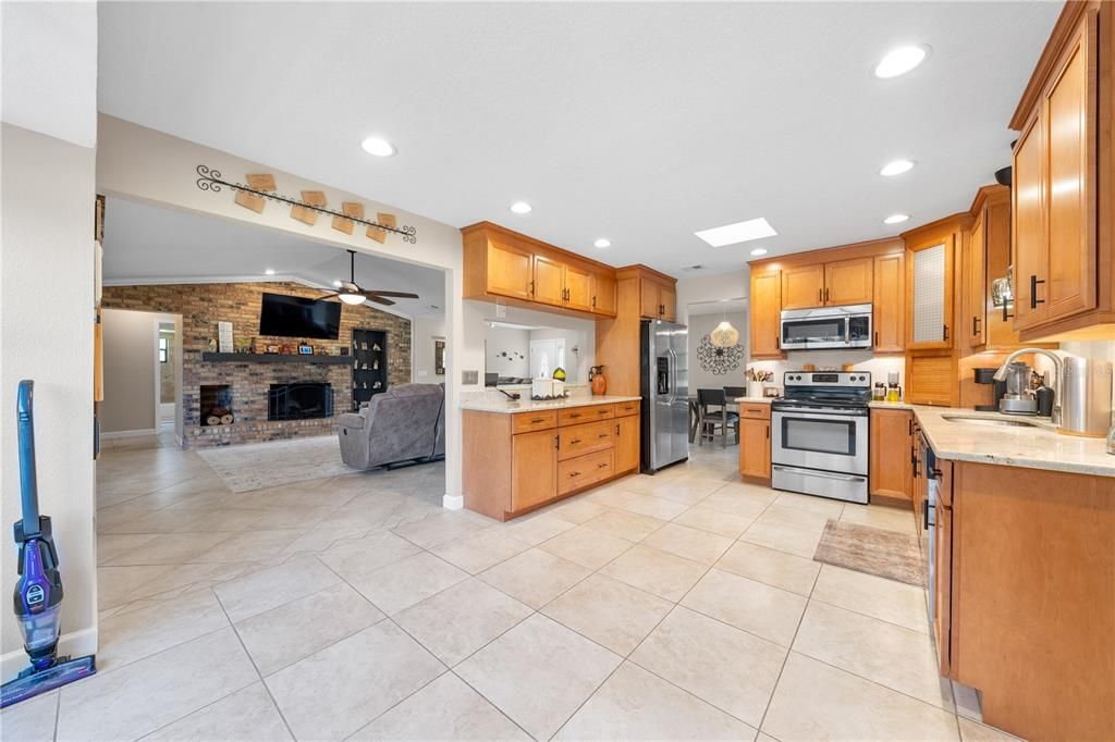 Fireplace, Interior, Kitchen, Recessed Lighting, Stainless Steel Appliances, Stone Walls