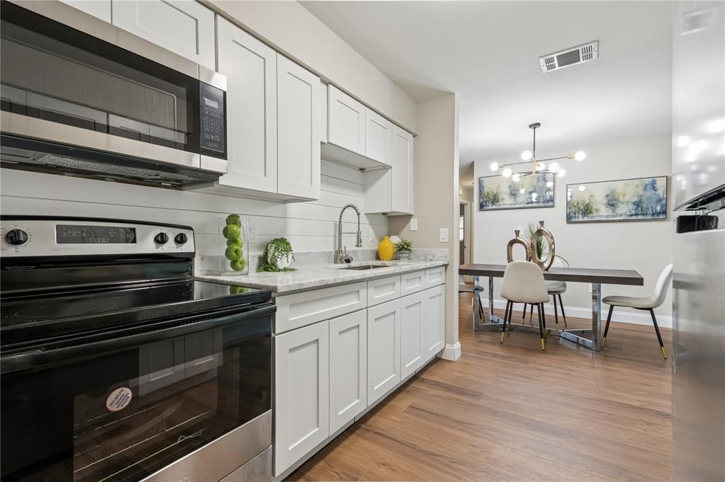 Dining room, Interior, Kitchen, Pendant Lights, Stainless Steel Appliances, Wood Texture Flooring