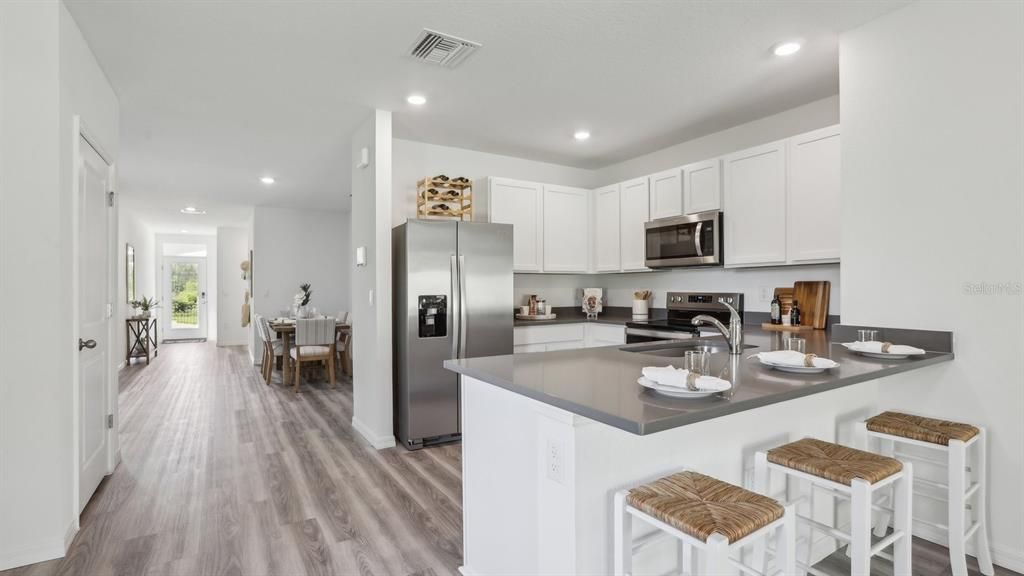Dining room, Interior, Kitchen, Recessed Lighting, Stainless Steel Appliances, Wood Texture Flooring