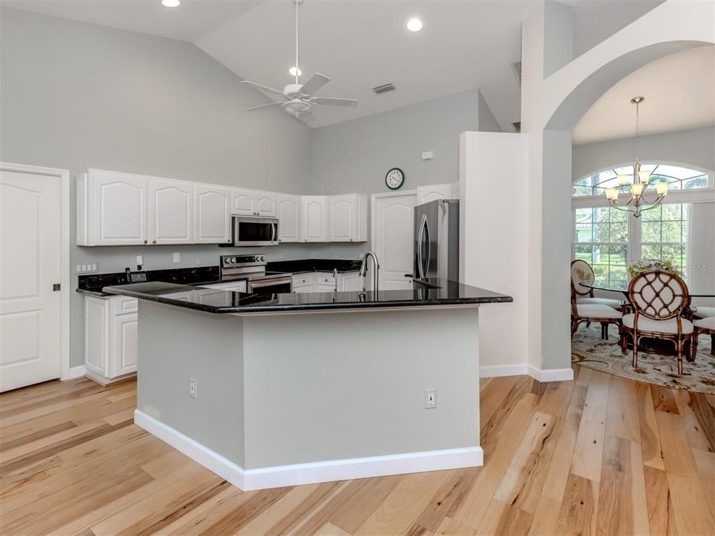 Chandelier, Dining room, Interior, Kitchen, Recessed Lighting, Stainless Steel Appliances, Wood Texture Flooring