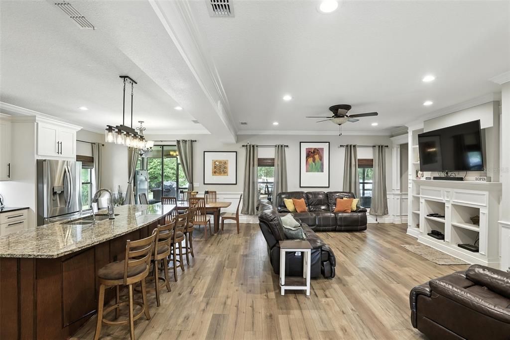 Chandelier, Dining room, Interior, Kitchen, Living room, Pendant Lights, Recessed Lighting, Stainless Steel Appliances, Wood Texture Flooring