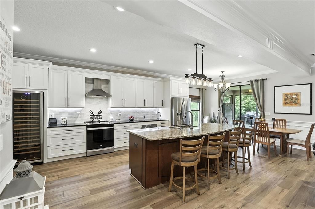 Chandelier, Dining room, Interior, Kitchen, Pendant Lights, Recessed Lighting, Stainless Steel Appliances, Wood Texture Flooring