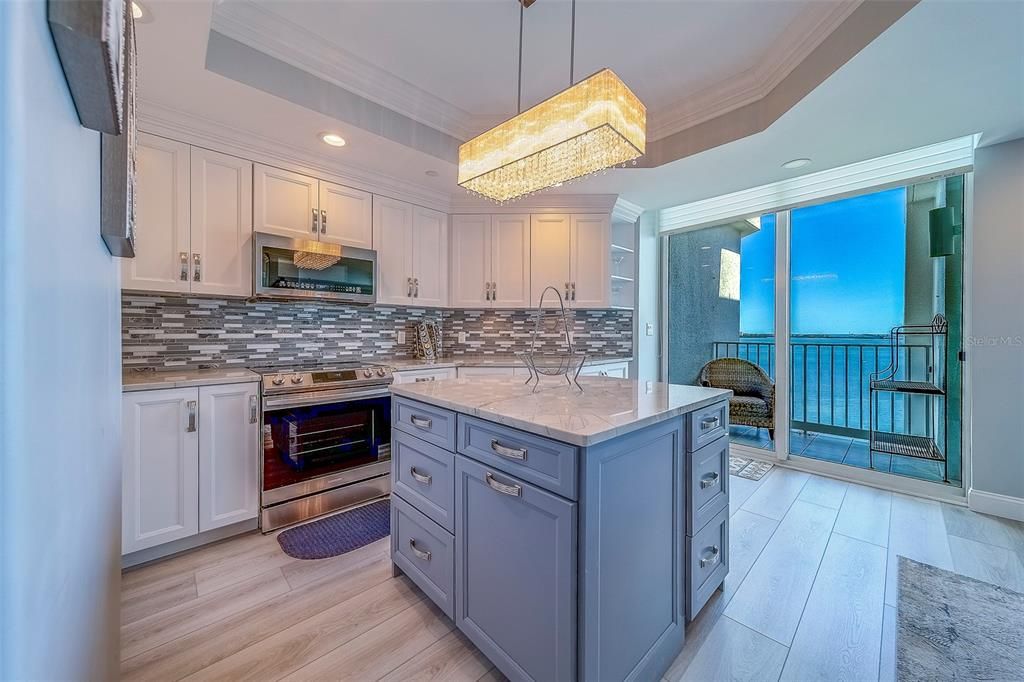 Chandelier, Interior, Kitchen, Pendant Lights, Recessed Lighting, Stainless Steel Appliances, Wood Texture Flooring