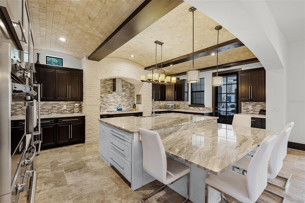 Chandelier, Interior, Kitchen, Pendant Lights, Recessed Lighting, Stainless Steel Appliances, Stone Walls